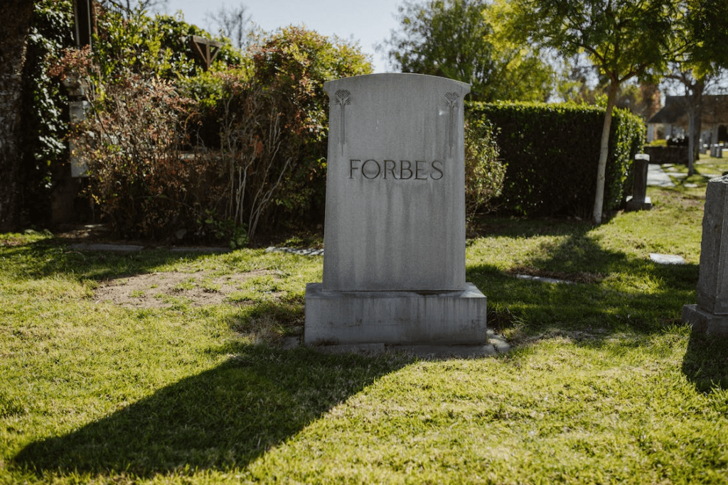 a gravestone on green grass